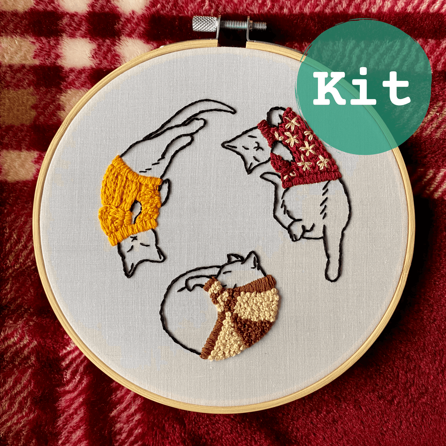 Cozy Sweater Kitties Embroidery Kit with cats in bright sweaters in a hoop.