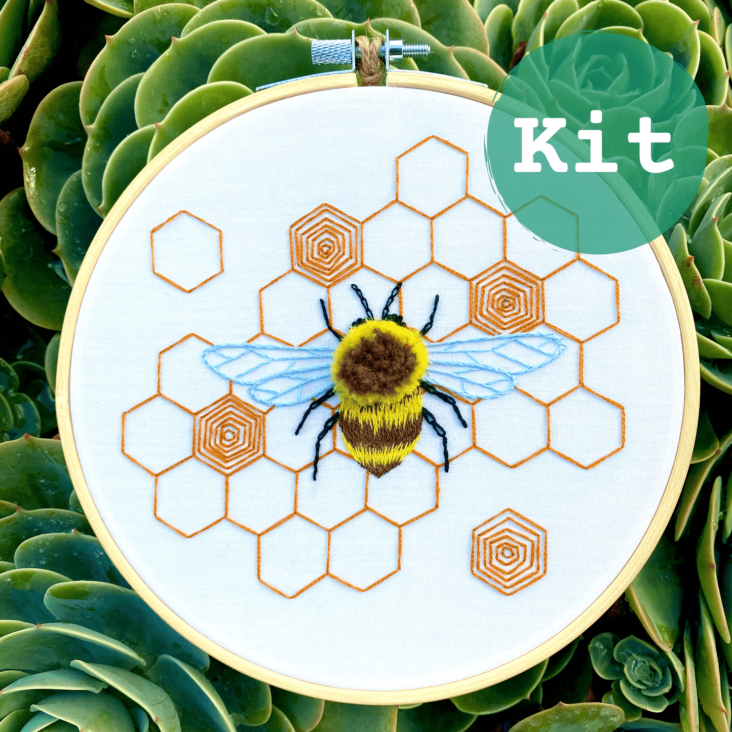 Fuzzy Bumblebee Embroidery Kit featuring 3D design on honeycomb; includes bamboo hoop, preprinted fabric, needle, and threads; ideal for intermediate stitchers.