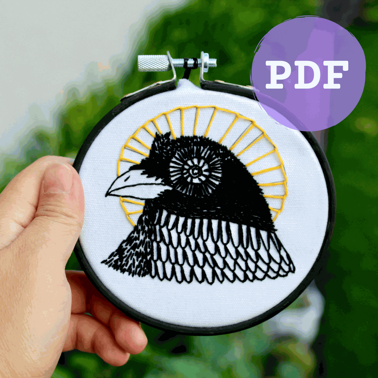 Embroidery pattern of a black bird with sun halo, DIY PDF download.