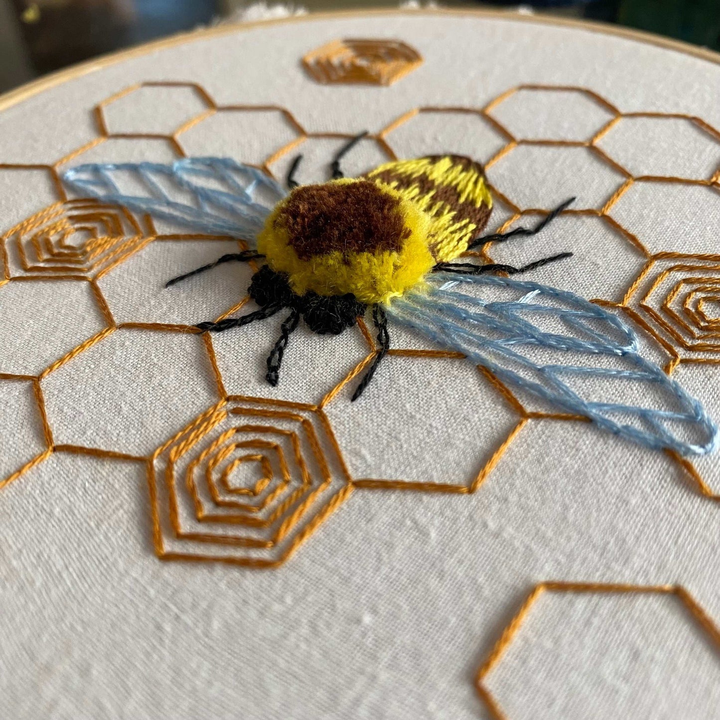 Fuzzy Bumblebee Embroidery Kit with 3D bumblebee on honeycomb, perfect for intermediate stitchers.