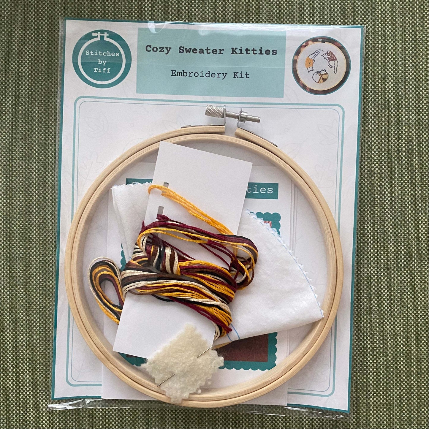Cozy Sweater Kitties Embroidery Kit with hoop, fabric, needle, and threads for beginners.