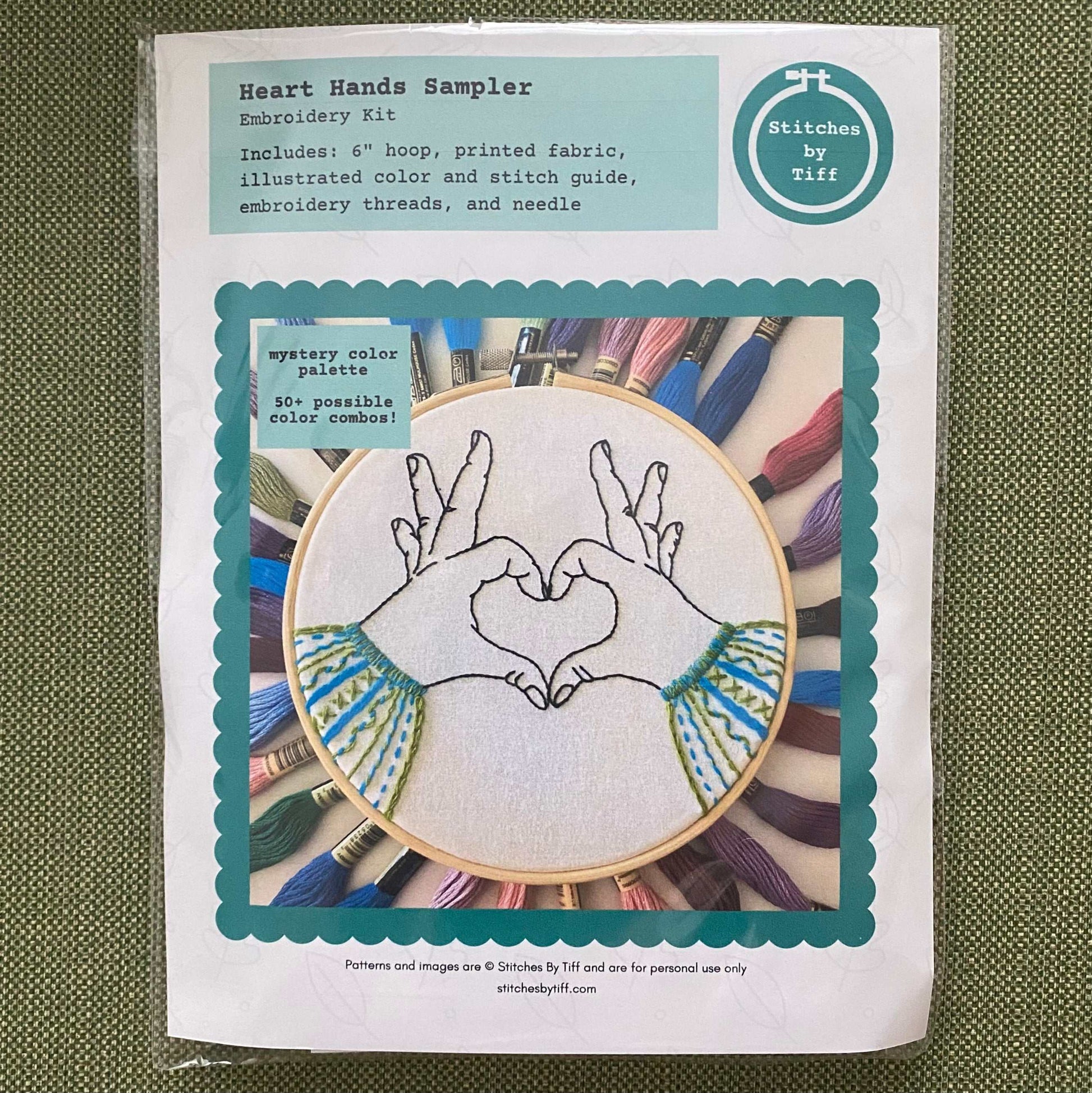 Heart Hands Sampler Embroidery Kit with bamboo hoop and colorful threads.