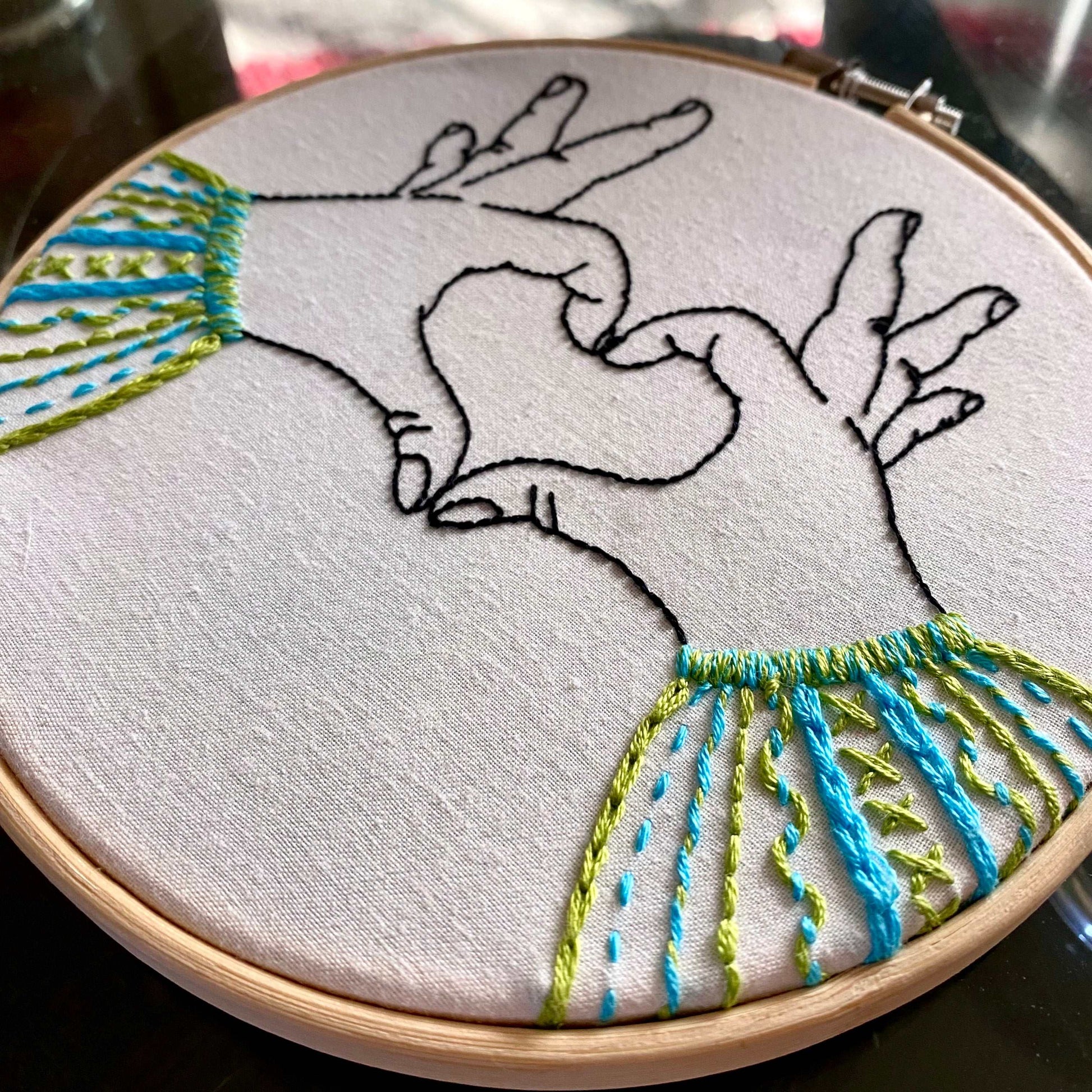 Heart Hands Sampler Embroidery Kit with bamboo hoop and colorful stitches.