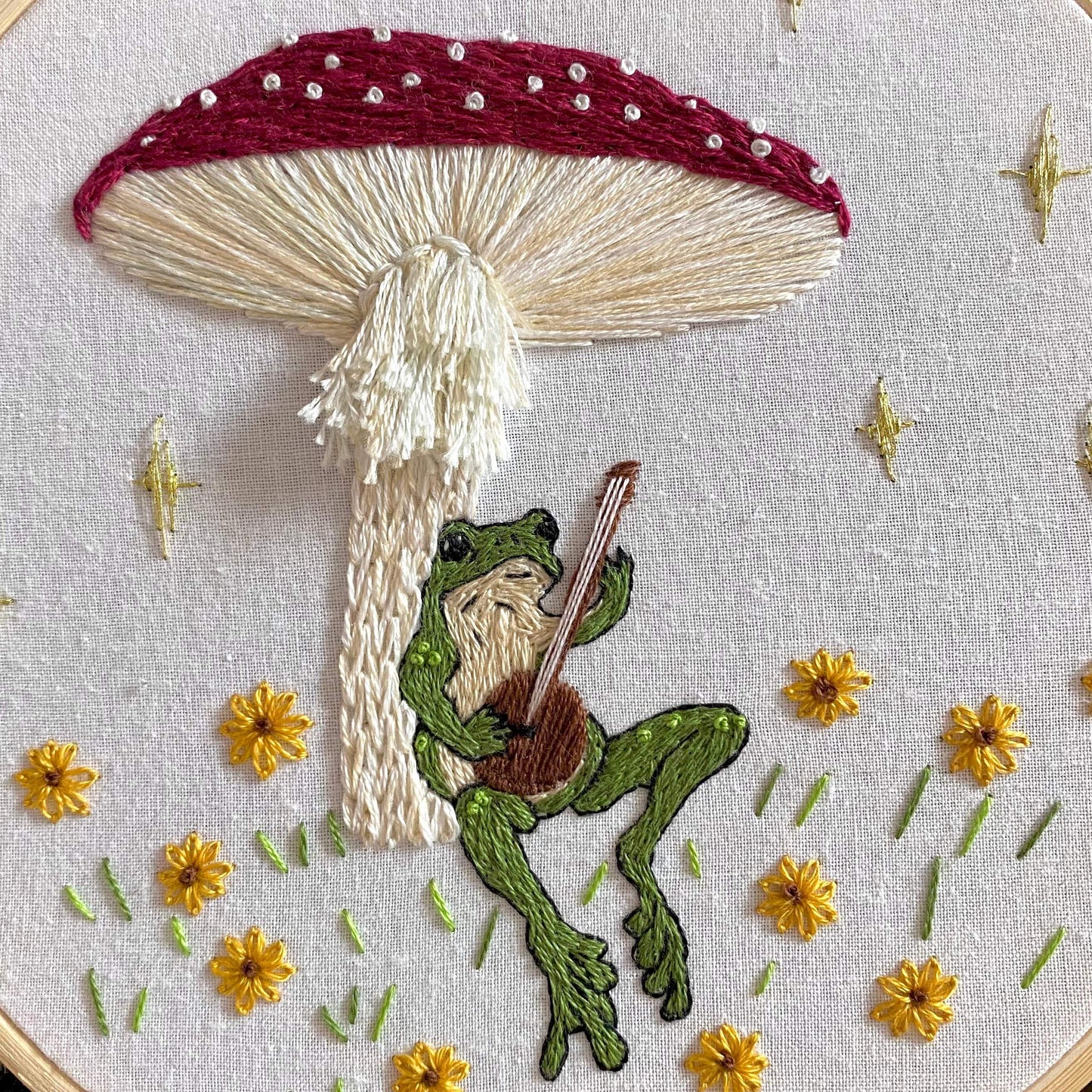 Toadstool Serenade Embroidery Kit featuring a frog with a lute under a mushroom, perfect for cottagecore decor and embroidery enthusiasts.
