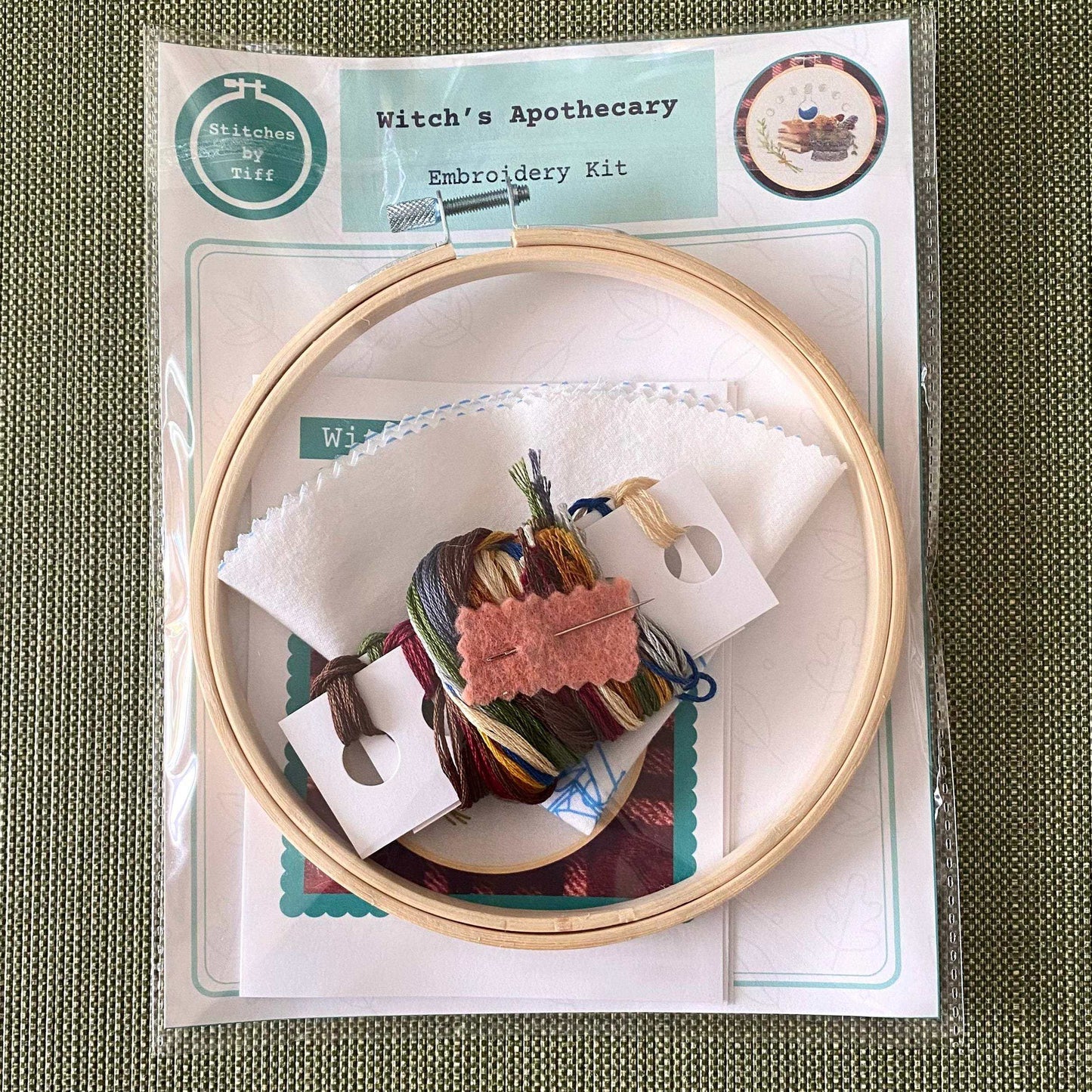 Witch's Apothecary Embroidery Kit with hoop, fabric, needle, thread, and guide for mindful crafting.