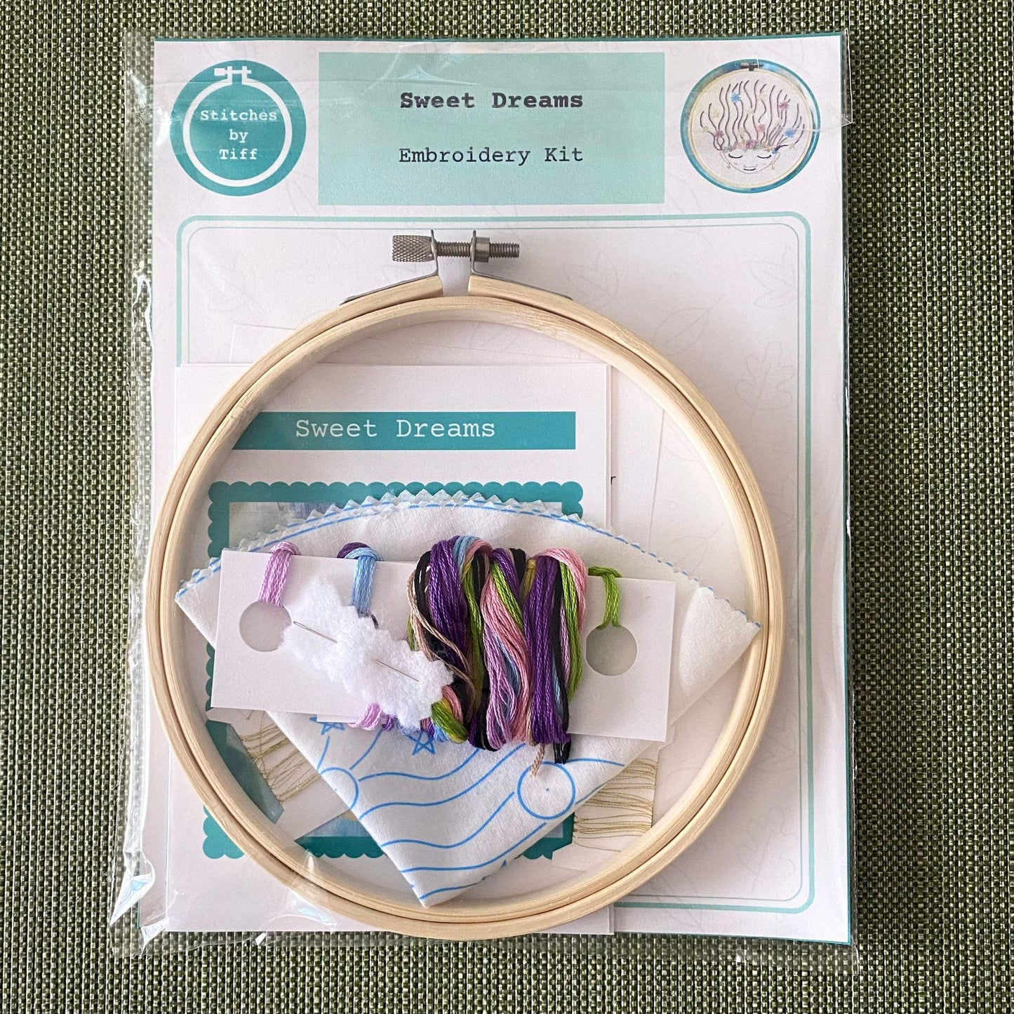Beginner-friendly Sweet Dreams embroidery kit with bamboo hoop, preprinted fabric, needle, and colorful threads.