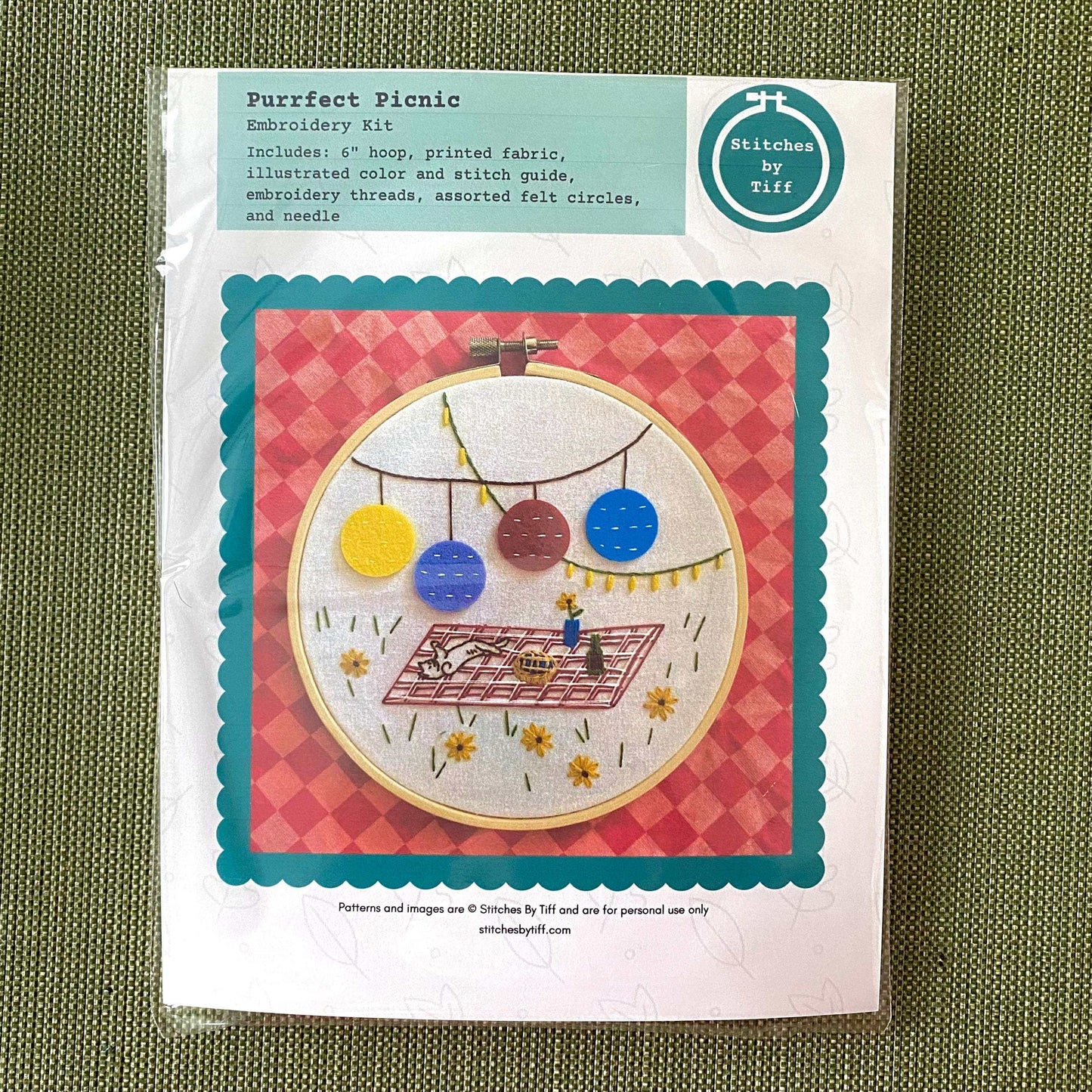 Purrfect Picnic Embroidery Kit with colorful picnic pattern, 6" hoop, pre-printed fabric, and felt circles for DIY craft.