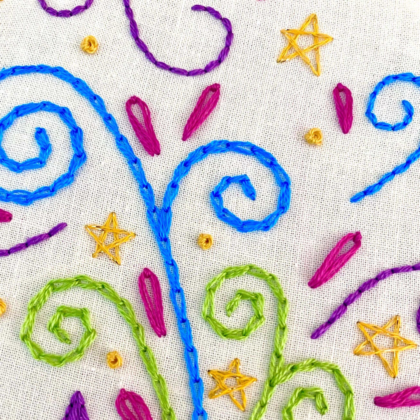 Colorful embroidery with swirls and stars from "The Meowgician Embroidery Kit."