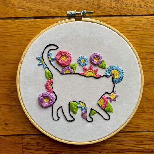 Cat In Bloom Embroidery Kit with floral design, bamboo hoop, and colorful threads for beginners.