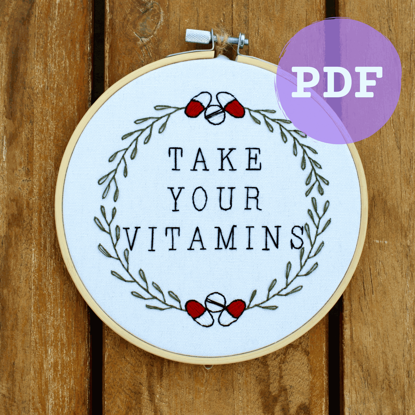 Take Your Vitamins embroidery PDF pattern with motivational quote and wreath design.