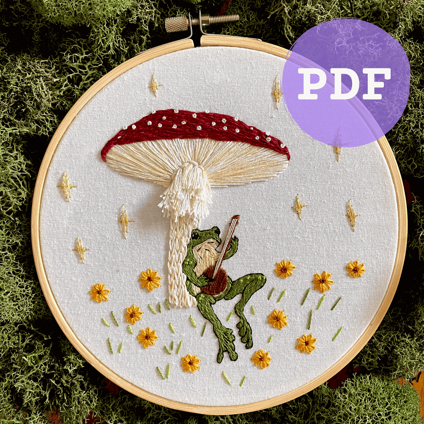 Toadstool Serenade embroidery PDF pattern with frog, mushroom, and flowers in hoop.