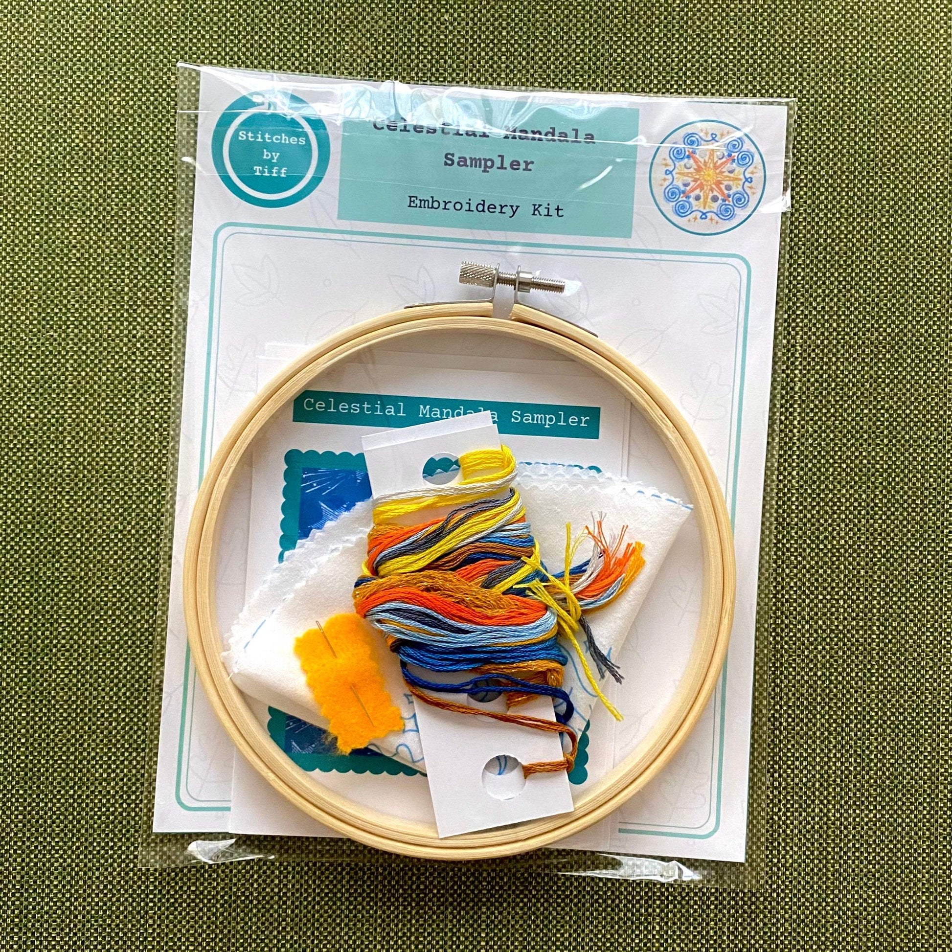 Celestial Mandala Sampler Embroidery Kit with bamboo hoop, colorful threads, and preprinted fabric.